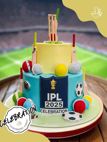 Hit it out of the park with this incredible IPL-themed cricket cake. This two-tier design is ready for a super over, decorated with bats, balls, and the IPL trophy.