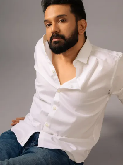 A classic white shirt and jeans look for Ankith Madhav. The grooming is effortless and masculine, perfect for creating a timeless and romantic vibe.