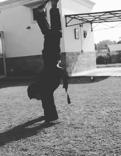 Flexibility is supported by strength. We incorporate bodyweight exercises like handstands to build a strong core and stable shoulders, which are essential for advanced martial arts movements and overall fitness.