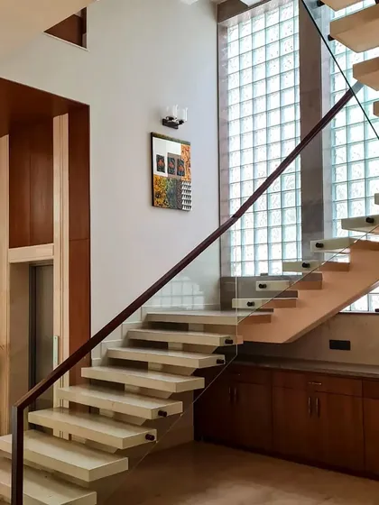 This staircase is adorned with the ethereal touch of glass bricks. The design uses structural metal wires and calming white cement to transform harsh light into soothing, natural reflections.