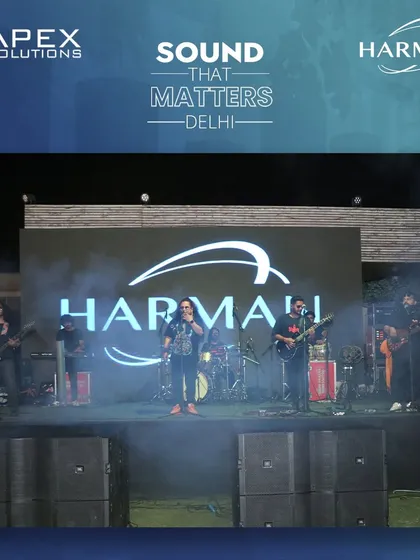 The Harman logo is displayed prominently on the LED screen as a band performs, demonstrating how we integrate client branding into the live production. This was part of a successful brand activation event.