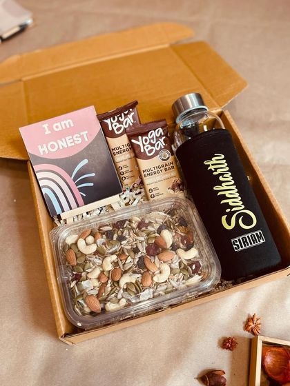 This corporate wellness box is a perfect gift for health-conscious employees. It includes a personalized glass bottle, Yoga Bars, a dry fruit mix, and motivational cards.