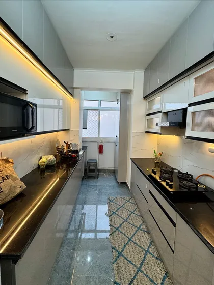 A look at a completed parallel kitchen in Amrapali Princly Estate. I focused on maximizing counter space and storage, using under cabinet LED lighting to create a bright and functional cooking environment.
