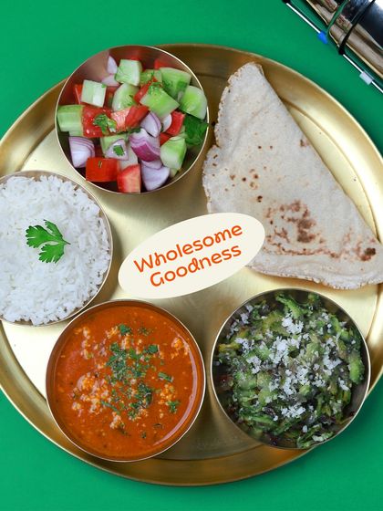 Wholesome goodness on a plate. This meal features a delicious paneer bhurji, a simple karela sabzi, soft jowar bhakri, rice, and a fresh kachumber salad.