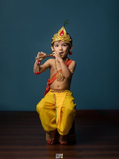 Little Krishna playing his flute, a classic and adorable pose.