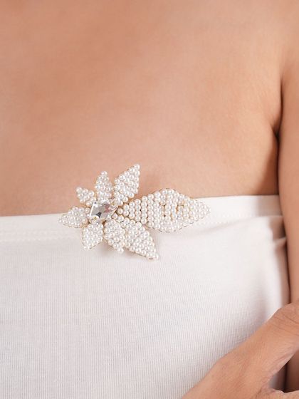 A simple tube top is instantly elevated with the addition of our handcrafted pearl and crystal leaf brooch.