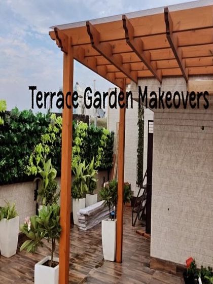 On this terrace, I installed a tall artificial green wall to create privacy and a lush, natural view. It pairs beautifully with the warm wood of the pergola and the clean white planters for a modern yet inviting feel.