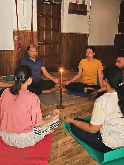 I often explain the technique and benefits of practices like Tratak meditation before we begin. Here, a group listens as we prepare to start our candle-gazing session.