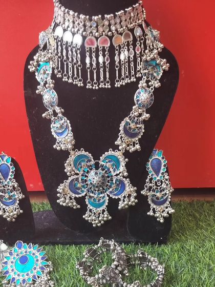 A blue and silver oxidised jewellery set with a large floral pendant, ideal for Garba nights.
