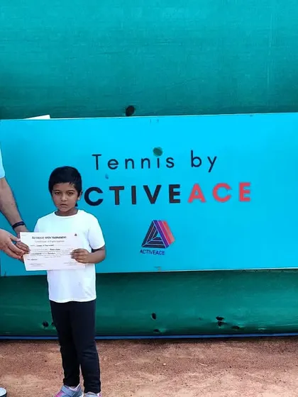 A young player receiving a certificate from our Chairperson, Mr. Balram Singh.