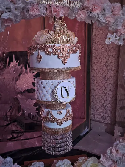 Another one of my chandelier cakes, this time with white and rose gold details, including a quilted middle tier and crystal hangings.