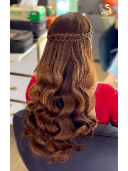 The hairstyle in the making, showing the beautiful waves before they are fully styled.