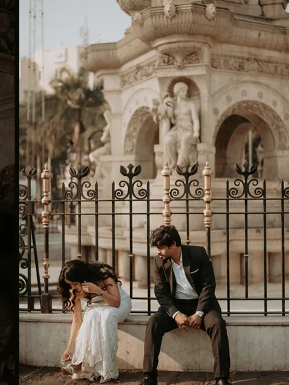 A candid moment of laughter and adjustment, showing the real, unposed side of a glamorous city photoshoot.
