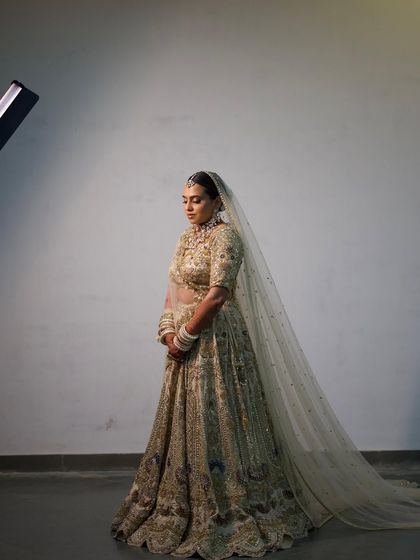 A dramatic, full-length shot of the bride, with her long veil creating a stunning silhouette.