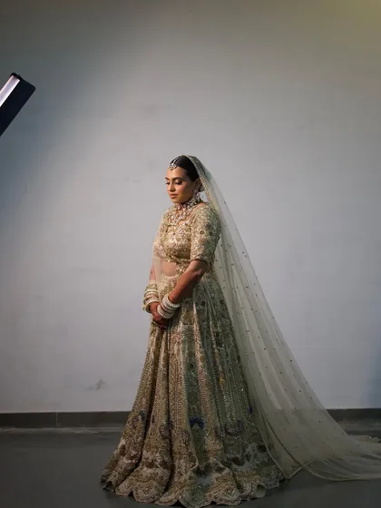 A dramatic, full-length shot of the bride, with her long veil creating a stunning silhouette.