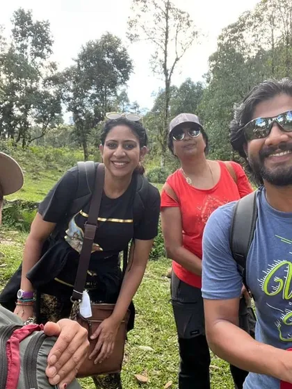 A group of us trekking through the lush green forests and trails of the Himalayas.