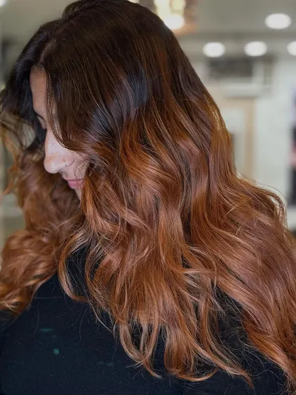 A candid shot of the client with the copper ombre, capturing the beautiful way the light hits the different tones in her hair.