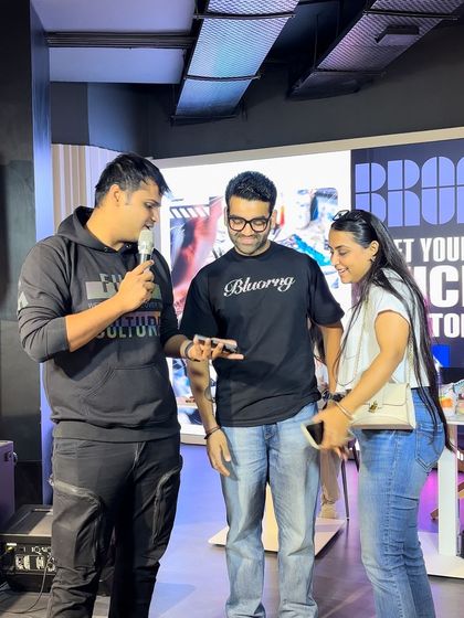 Our host interacting with guests on stage during a live event. We keep the energy high and engage the crowd, explaining the customization process and showcasing finished pieces.