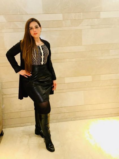 Another shot of this edgy and chic outfit. The combination of textures with the leather skirt and long coat adds depth and interest to the look.