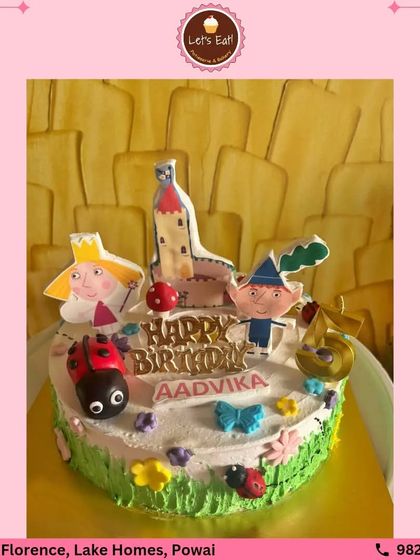 A magical cake inspired by Ben & Holly's Little Kingdom. This design features edible toppers of the main characters, a ladybug, and a castle, set on a whimsical garden of buttercream frosting.