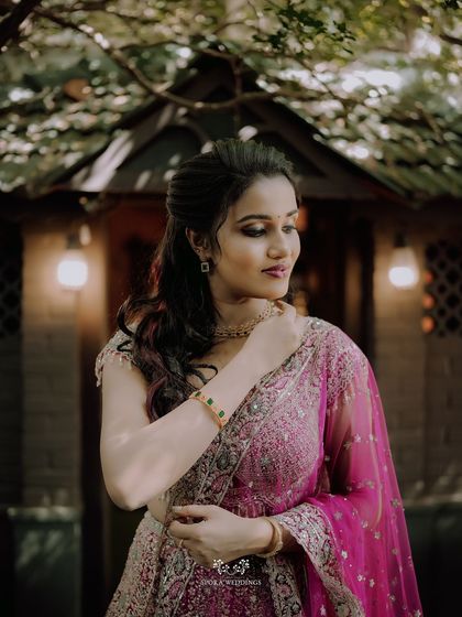 A beautiful portrait of the bride-to-be, her hand delicately touching her jewelry, her expression one of happy anticipation.