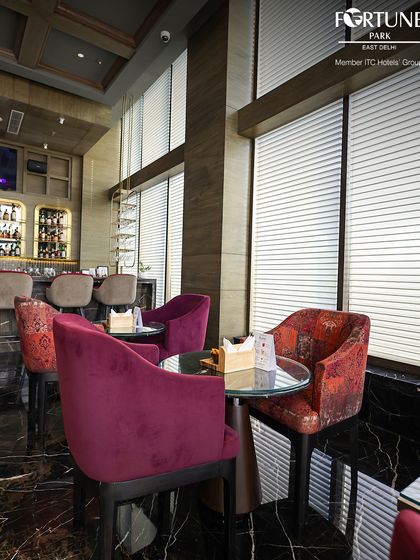 A view of the seating area at Neptune, with its mix of patterned and solid color armchairs creating a stylish and eclectic look.