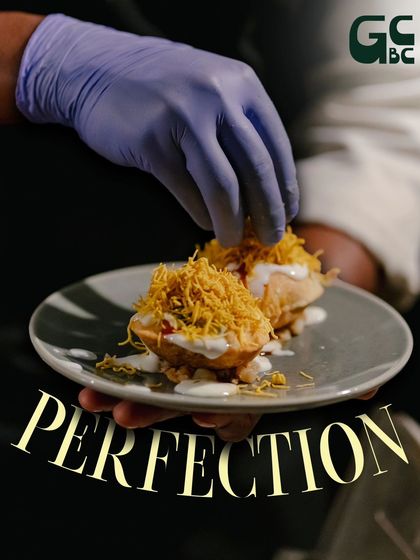 A chef adding the final touches to our popular dahi puri. It's this dedication to perfection that I'm so proud of in my team.