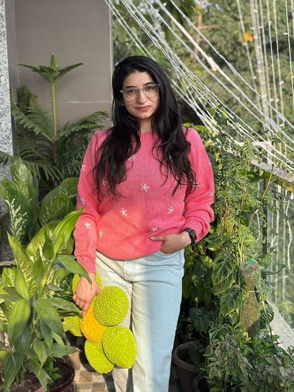 This soft pink sweater is embroidered with delicate white stars, giving it a dreamy and whimsical feel. It’s a simple pullover design elevated by the handmade details stitched with care.