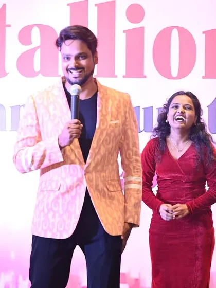Sharing a laugh with a co-host on stage. My ability to build instant rapport with others ensures a smooth and entertaining show, whether I am hosting solo or as part of a team.