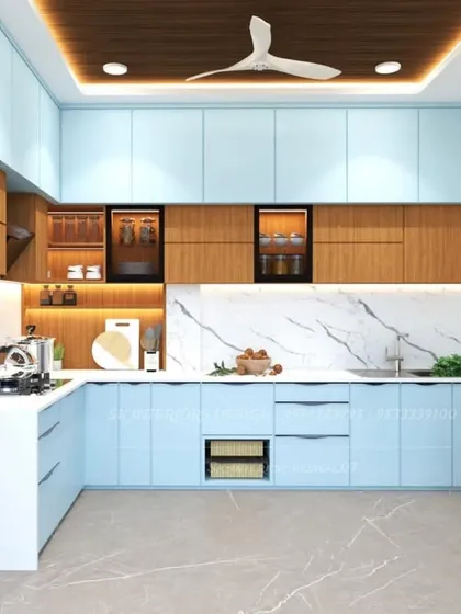 A bright and cheerful L-shaped kitchen with light blue and wood cabinets. The design incorporates open shelving, wicker baskets for vegetables, and space for a washing machine.