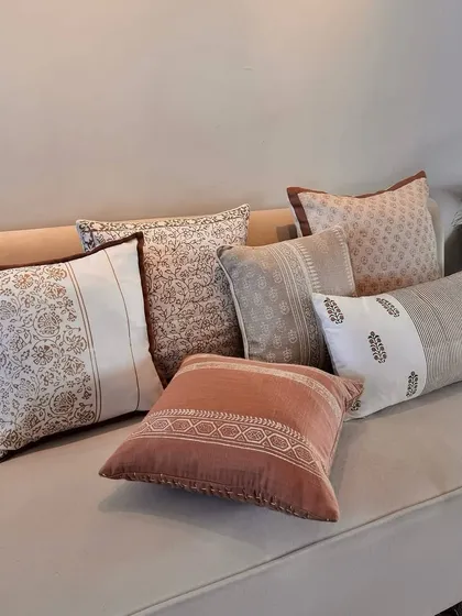 This collection of hand-designed block print cushions features a serene neutral color palette. The mix of floral, geometric, and striped patterns creates a sophisticated and timeless look, perfect for any living space.