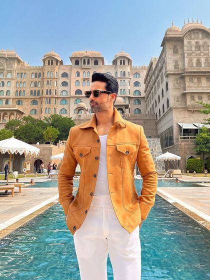 Another shot from the luxury resort, this image perfectly frames the jacket against a stunning poolside backdrop.