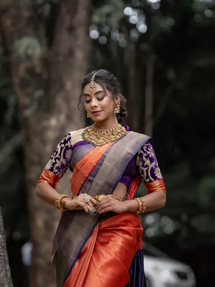 A moment of quiet grace, the model's pose reflecting the timeless elegance of the Kanchipuram silk saree.