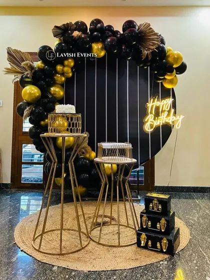 A sleek and modern black and gold themed setup for a sophisticated party.