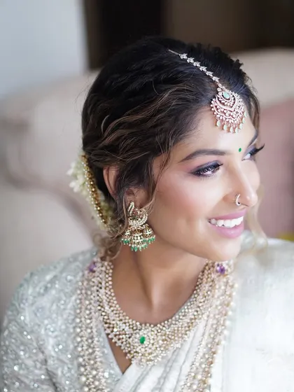 The beautiful bride Reshma, glowing for her engagement. This angle highlights the soft contouring and the way the makeup enhances her radiant smile and sparkling eyes.