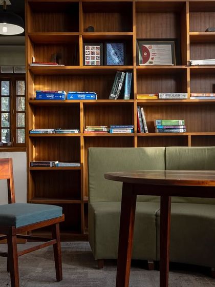 We believe learning spaces should be comfortable and inviting. This corner of a common area features warm wood shelving and soft seating, creating a relaxed atmosphere for students.