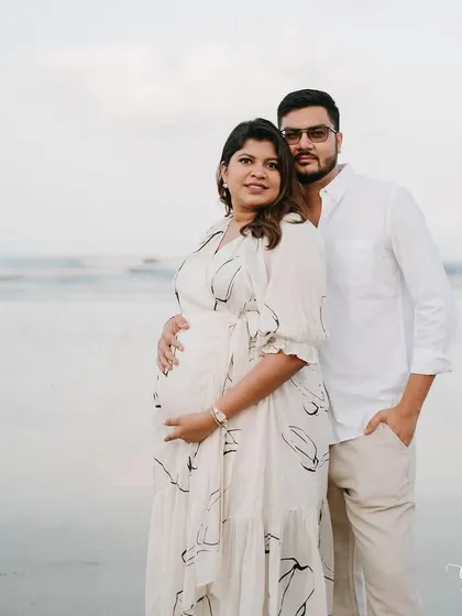 A beautiful portrait of the couple. Her radiant makeup enhances her natural pregnancy glow, creating a timeless and heartwarming image.