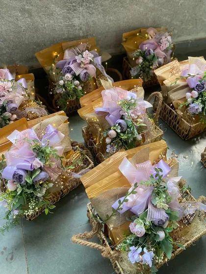 A closer look at our lavender-themed wicker basket hampers. The combination of rustic baskets, soft tulle, fairy lights, and lush floral arrangements creates a magical and enchanting gift experience.