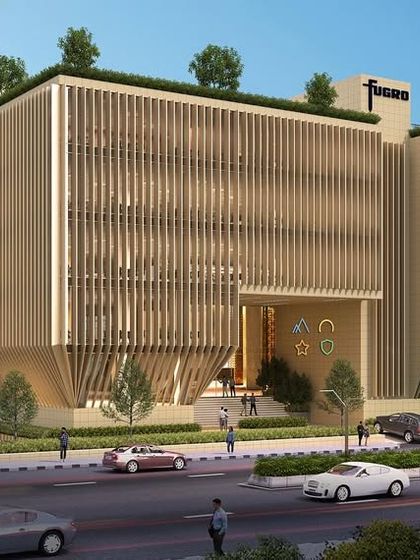 This commercial building in Navi Mumbai uses a material palette of native yellow basalt, aluminum, and DGU glass. The design is a study in contextual sustainability, creating a durable and climate-responsive envelope.