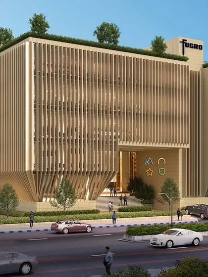 This commercial building in Navi Mumbai uses a material palette of native yellow basalt, aluminum, and DGU glass. The design is a study in contextual sustainability, creating a durable and climate-responsive envelope.