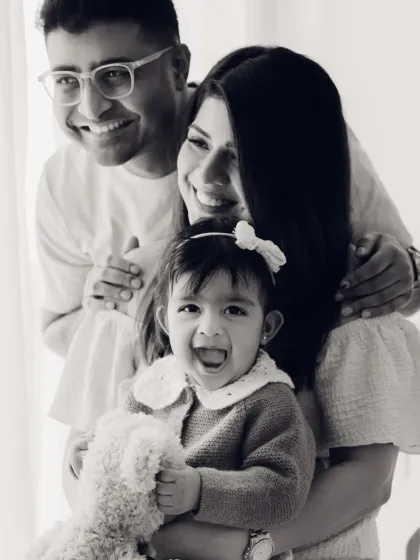 A classic family portrait in black and white, full of smiles. This timeless style is perfect for creating heirloom images.