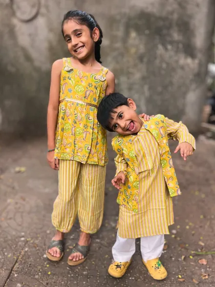 (Hero Item) This is what pure joy looks like. I design my sibling sets so that your little ones can share smiles, hugs, and adventures in outfits that are as comfy as they are cute. This matching yellow set is made from the softest cotton, perfect for festive fun without any fuss.