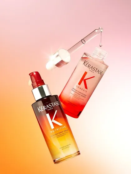 A dynamic shot of Kérastase serums with droppers, showing the product in action. These are perfect for adding shine and fighting frizz.
