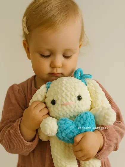 Nothing makes us happier than seeing our creations find a loving home. This adorable, baby-safe bunny, made from soft chunky yarn, is designed for the gentlest of cuddles. We use only natural, skin-friendly materials in all our kids' toys.