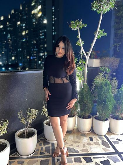 A front-facing shot of the black mesh dress. This gives a clear view of the outfit's design and fit.