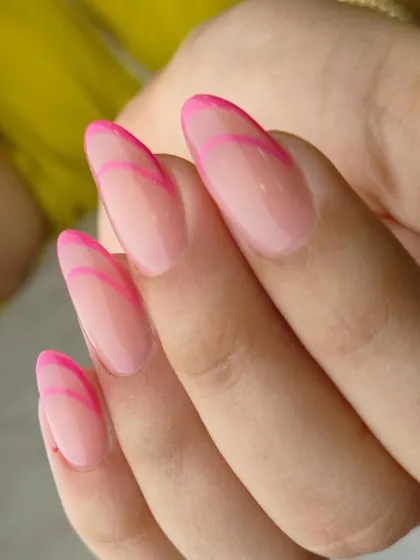A minimalist yet eye-catching design. This modern French manicure uses two tones of pink to create a simple, graphic outline on a sheer base.