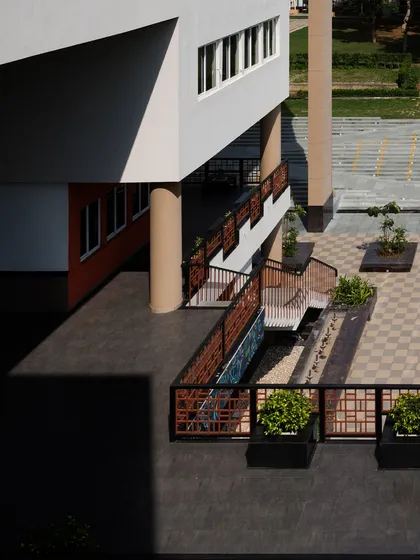 An overhead view of the Sushant School of Design & Architecture shows the interplay of volumes and voids. The massing casts dramatic shadows, turning sunlight into a design element that animates the building and cools the spaces below.