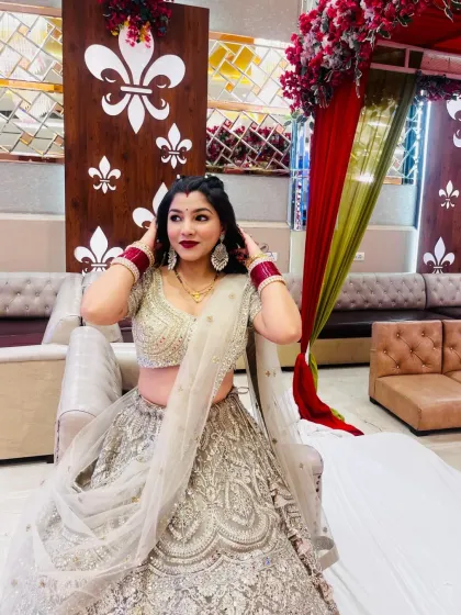 A series of photos of my happy client looking absolutely stunning in a heavily embroidered silver-grey lehenga at her reception. She owned the look completely!