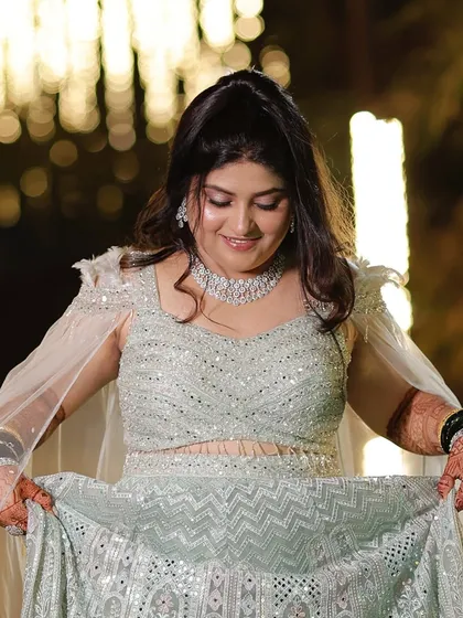 A closer look at this sangeet lehenga. The makeup is kept soft and pretty, with a focus on glowing skin and a hint of pink on the eyes and lips.