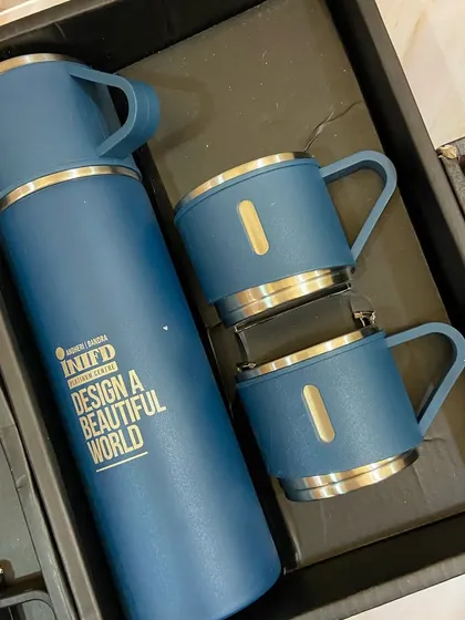 Here's what's inside the golden box: a stylish branded thermos and mug set from INIFD, showcasing our ability to source and customize high-quality merchandise.